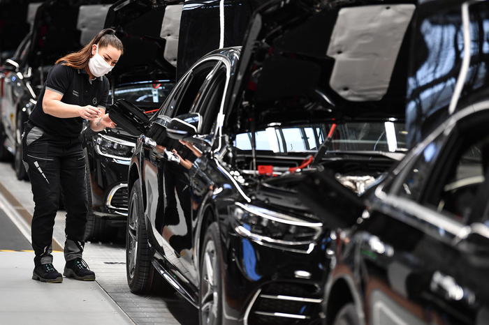 epa08641359 A worker assembles the new Mercedes S-class during a press event for the opening of the Factory 56 production slated  line in Sindelfingen, Germany, 02 September 2020. The German car manufacturer's newly built production complex for the new S-class covers an area of roughly 30 soccer fields. According to the company, it operates carbon neutral and fully digitalized.  EPA/PHILIPP GUELLAND