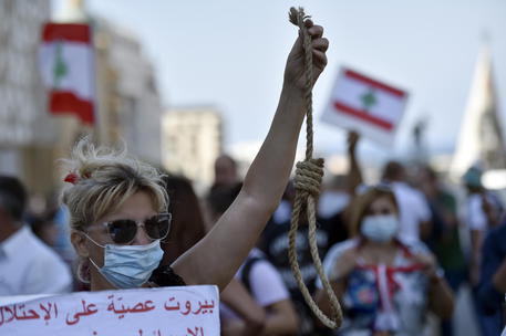 epa09251573 An anti-government protester carries a mock gallows rope symbolizing the execution of Lebanese politicians during a protest against the power cuts, the high cost of living, and the low purchasing power of the Lebanese pound, in downtown Beirut, Lebanon, 06 June 2021. According to a World Bank report released on 01 June 2021, Lebanon's severe economic and financial crisis likely to rank as one of the worst the world has seen in more than 150 years.  EPA/WAEL HAMZEH