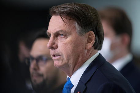 epa09108689 Brazilian President Jair Bolsonaro participates in a press conference at the Palacio do Planalto, in Brasilia, Brazil, 31 March 2021. Bolsonaro criticized the measures that seek to restrict the movement of the population in the face of the coronavirus pandemic and assured that 'hunger kills much more than the virus itself'.  EPA/JOEDSON ALVES