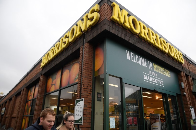 FILE PHOTO: Shoppers walk past a branch of the food retailer Morrisons in west London, Britain, January 7, 2017. REUTERS/Toby Melville/File Photo