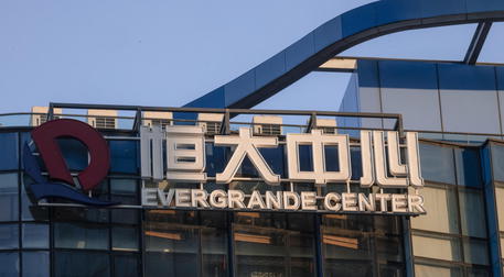epa09479216 The Evergrande Center logo hangs outside a building in Shanghai, China, 21 September 2021. Evergrande Group is ChinaÂ’s real estate conglomerate and the worldÂ’s most indebted property developer. Stock markets in Asia, the USA, and Europe were hit by a major sell-off on 20 September since the companyÂ’s shares closed 10 percent lower in Hong Kong. The Evergrande Group announced its concern in a stock filing this month that the group might not be able to meet its financial obligations.  EPA/ALEX PLAVEVSKI