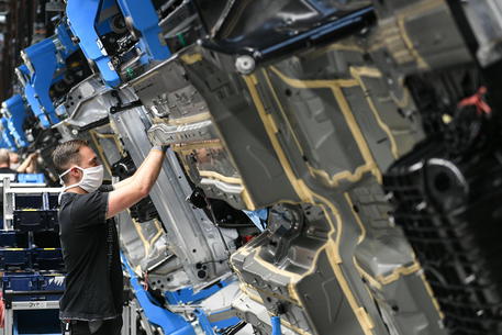 epa08641346 A worker assembles the new Mercedes S-class during a press event for the opening of the Factory 56 production slated  line in Sindelfingen, Germany, 02 September 2020. The German car manufacturer's newly built production complex for the new S-class covers an area of roughly 30 soccer fields. According to the company, it operates carbon neutral and fully digitalized.  EPA/PHILIPP GUELLAND