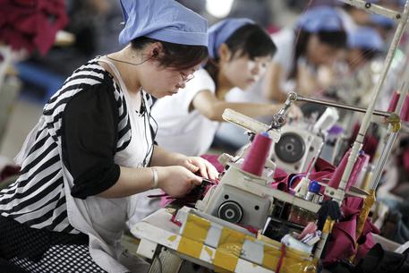 epa04778563 Female workers make clothes for export to Germany at a clothing factory in Huaibei, Anhui province, east China, 01 June 2015. China's official purchasing managers' index (PMI) rose to 50.2 in May from 50.1 in April, reports stated. A survey from financial services company HSBC showed China's total new business fell for the third month running as new export business fell at the sharpest rate in two years. HSBC's purchasing manager's index posted 49.2 in May, up from 48.9 in April.  EPA/STRINGER CHINA OUT
