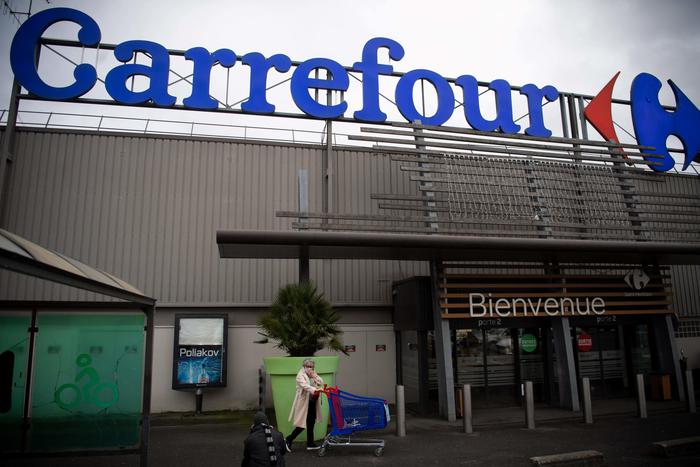 A woman enters a French retail giant Carrefour surpermarket, on January 13, 2021 in Saint-Herblain, outside Nantes. - Canadian convenience store group Alimentation Couche-Tard has approached France's Carrefour about a takeover that would combine two retail groups jointly worth more than $50bn.
The talks were at an early stage, the companies said on January 12, 2021 in separate statements. (Photo by LOIC VENANCE / AFP)