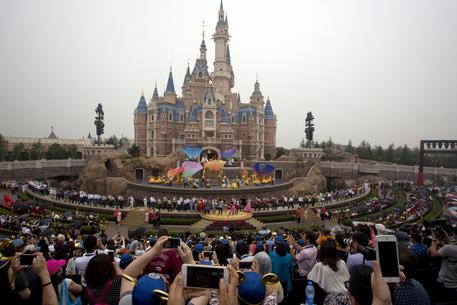 Performers take to the stage during the opening ceremony for the Disney Resort in Shanghai, China, Thursday, June 16, 2016. Walt Disney Co. opened its first theme park in mainland China on Thursday at a ceremony that mixed speeches by Communist Party officials, a Chinese children's choir and actors dressed as Sleeping Beauty and other Disney characters. (ANSA/AP Photo/Ng Han Guan) [CopyrightNotice: Copyright 2016 The Associated Press. All rights reserved. This material may not be published, broadcast, rewritten or redistribu]
