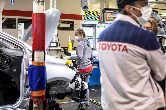 epa08389680 Toyota employees wear protective face masks while working at the car manufacturing plant where the Yaris model is assembled for the European market in Onnaing, near Valenciennes, northern France, 28 April 2020. Toyota is the first vehicle plant reopening in France since the start of the national lockdown due the ongoing coronavirus COVID-19 pandemic. Only one third of the employees returned to work, having to respect strong safety measures. The challenge is to learn how to work differently from now on. The workers' temperature is checked upon arrival and they have to wear a mask which they should change twice a day. EPA/SEBASTIEN COURDJI