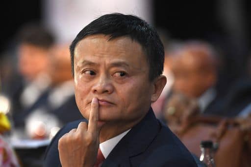 (FILE) This photo taken on October 26, 2018 shows co-founder of China's Alibaba Jack Ma gesturing as he attends an international investment conference in Johannesburg. - Jack Ma, founder of Chinese tech giant Alibaba, is among the world's richest people but he has now emerged as a member of another club: China's 89-million-strong Communist Party. In an article on November 26, the People's Daily said Ma was a party member who has played an important role in pushing China's Belt and Road global trade infrastructure initiative -- a pet project of President Xi Jinping. (Photo by STR / AFP)