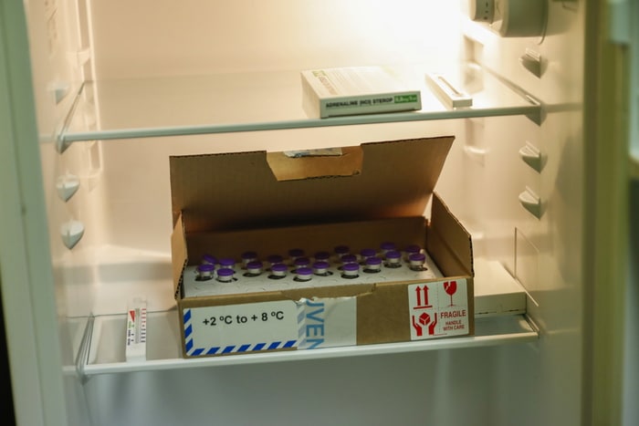 epa08907213 A box containing vials of the COVID-19 vaccine are stored at the La Bonne Maison de Bouzanton care home in Mons, Belgium, 28 December 2020. The vaccine, developed by BioNTech and Pfizer, was transported from a hospital in Leuven to the residential care home on 28 December as Belgium begins its vaccination program starting with the most vulnerable.  EPA/FRANCISCO SECO / POOL