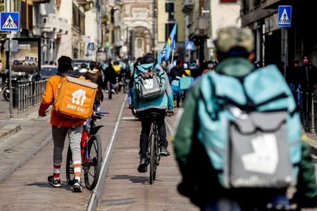 Food delivery bike riders hold a demonstration in Milan, Italy, 26 March 2021. The riders are demanding a real contract, with real protections, concrete guarantees, fairness and respect for their work with adequate remuneration. ANSA/ MOURAD BALTI TOUATI