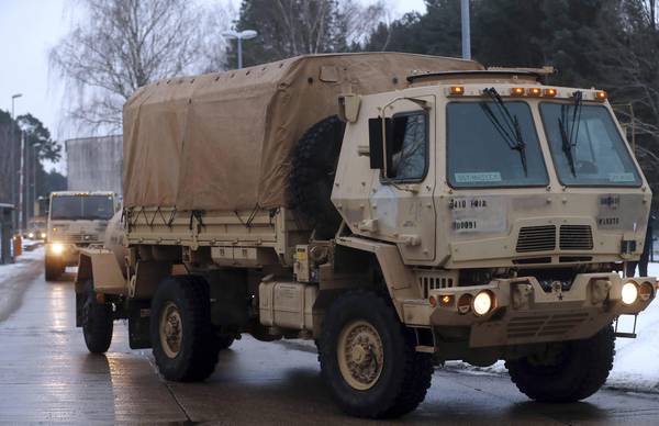 epa05710445 Military trucks part of a United States convoy leaves the German army compound in Brueck, near Lehnin, Germany, 11 January 2017. After spending the night 80 kilometres outside Berlin, two US convoys formed of 20 vehicles each are moving towards the Polish border as part of the Operation Atlantic Resolve. More than 2,500 tanks, trucks and other vehicles of the US Army are part of what is the biggest troop transfer from the US to Europe since the end of the Soviet Union.  EPA/FELIPE TRUEBA