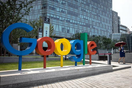 epa08979756 (FILE) - A Chinese woman walks past a 'Google' brand name and logo, near the Google office in Beijing, China, 03 August 2018 (reissued 01 January 2021). Alphabet, the parent company of internet giant Google, is due to publish their 4th quarter 2020 results on 02 January 2021.  EPA/ROMAN PILIPEY *** Local Caption *** 54599547