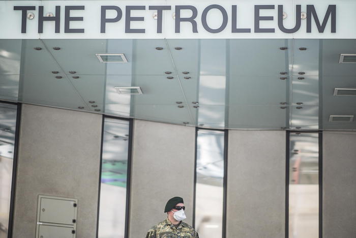 epa08353327 An Austrian Armed Forces soldier wearing a face mask patrols in front of the Organization of Petroleum Exporting Countries (OPEC) headquarters in Vienna, Austria, 09 April 2020. According to reports Ministers of the OPEC member states discuss SARS-CoV-2 coronavirus, which causes the Covid-19 disease, effects on the oil business in a video conference today.  EPA/CHRISTIAN BRUNA