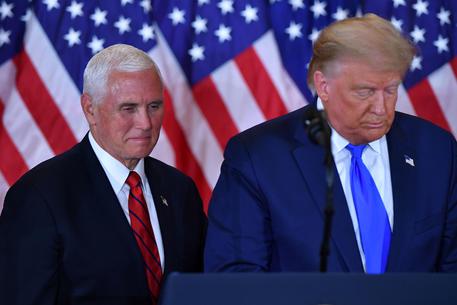 (FILES) In this file photo US President Donald Trump and US Vice President Mike Pence(L) speak during election night in the East Room of the White House in Washington, DC, early on November 4, 2020. - US Vice President Mike Pence is opposed to using the constitution's 25th Amendment to force President Donald Trump from office, despite pressure from democrats and some Republicans, the New York Times reported on January 7, 2021. While Pence has not spoken publicly about invoking the mechanism, never used before in US history, the newspaper cited a person close to the vice president saying he is against the radical move. (Photo by MANDEL NGAN / AFP)