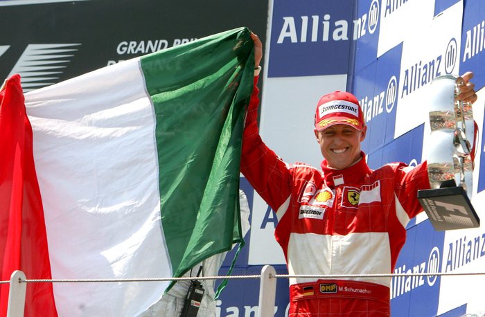 German Formula One driver Michael Schumacher of the Scuderia Ferrari team celebrates with Italian flag on the podium after winning the French Grand Prix at the Magny Cours race track near Nevers in France on Sunday 16 July 2006.  ANSA - RAINER JENSEN