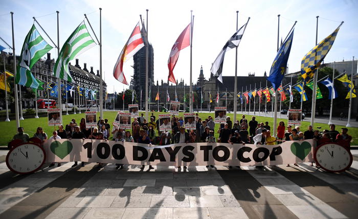 epa09359319 Climate change campaigners protest outside Parliament in London, Britain, 23 July 2021. Climate change protesters are calling for action from the UK government with 100 days to go before COP, the Climate Change summit to be held in Glasgow in November.  EPA/ANDY RAIN