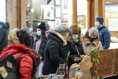 Gente con la mascherina mentre fa acquisti ai mercatini di natale. Torino 05 dicembre 2021 ANSA/TINO ROMANO