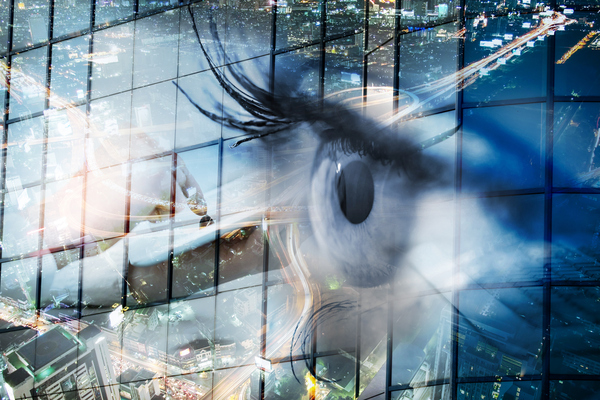 Eye looks to the future business. Woman's eye in the double exposure of a modern city and technology.Eye looks to the future business. Eye women in double exposure with charts and diagrams business.