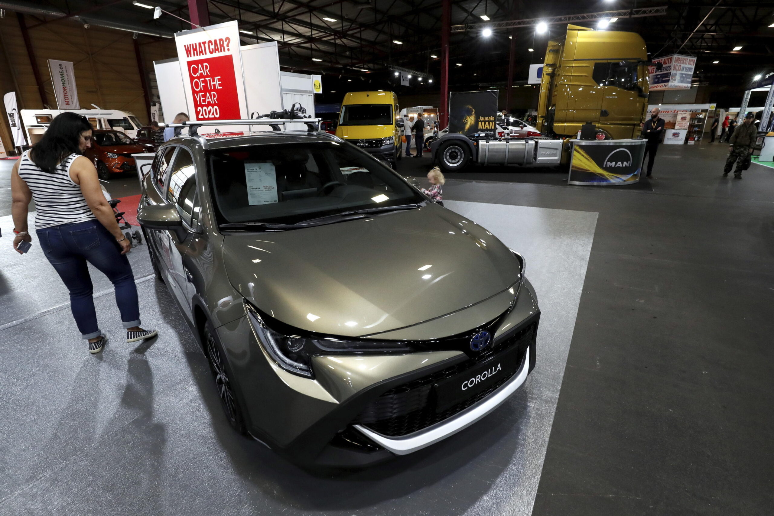 epa08696671 A visitor looks at a Toyota Corolla car during the International Motor Show Auto 2020, in Riga, Latvia, 25 September 2020. The automotive industry event is the biggest in the Baltic countries and runs from 25 to 27 September.  EPA/Toms Kalnins