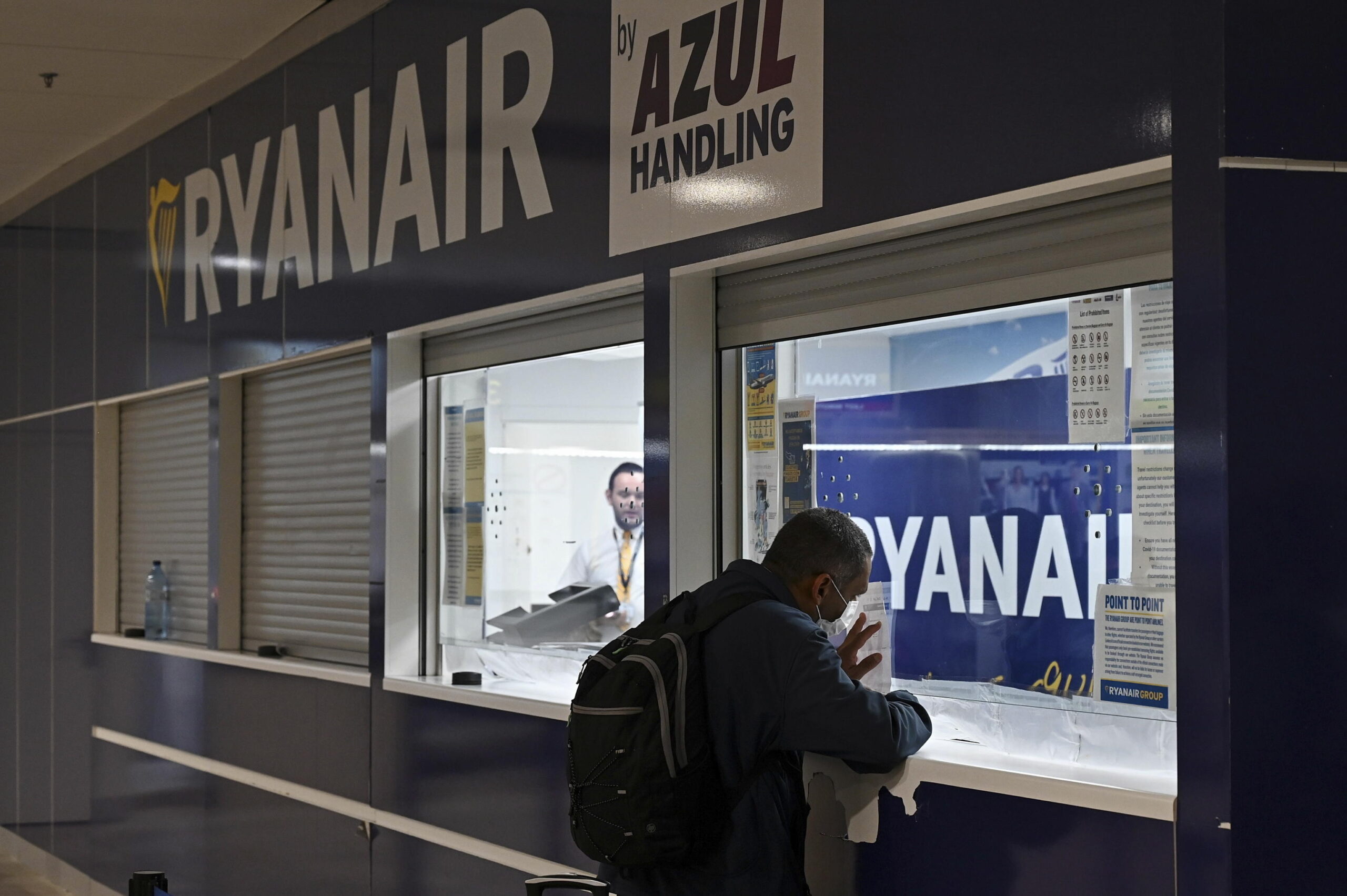 epa10031462 A man at a Ryanair customer service desk during the first day of strike called by Ryanair crew, at Adolfo Suarez Madrid Barajas international airport, in Madrid, Spain, 24 June 2022. Ryanair employees in Spain called for a strike on 24-26 June, 30 June and 01-02 July over dissatisfaction with working conditions and pay. More budget airlines across several European countries are expected to strike throughout July 2022.  EPA/FERNANDO VILLAR
