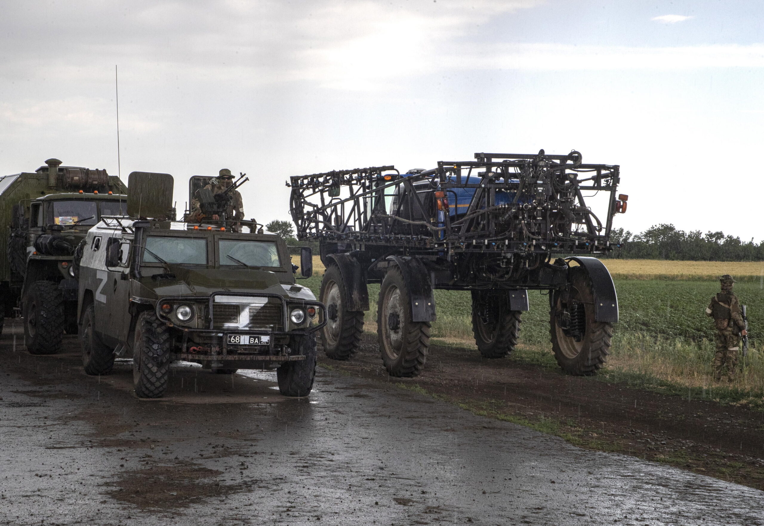 epa10013938 Russian servicemen and their vehicles seen near an agricultural tractor in front of a wheat field near Melitopol, Zaporizhia region, Ukraine, 14 June 2022 (Issued on 15 June 2022). The conflict in Ukraine has affected the availability and price of wheat worldwide. The Food and Agriculture Organization (FAO) of the United Nations said in its 10 June note assessing the risks emanating from the conflict in Ukraine that 'the current war raises concerns over whether crops will be harvested. It has already led to the closures of ports and oilseed crushing operations, affecting products intended for the export markets'. These are taking a toll on the country's exports of grains and vegetable oils. The city of Melitopol is located on the territory controlled by the troops of the Russian Federation and the city is administered by the Military-Civilian Administration controlled by Russia. On 24 February 2022 Russian troops entered the Ukrainian territory in what the Russian president declared a 'Special Military Operation', starting an armed conflict that has provoked destruction and a humanitarian crisis.  EPA/SERGEI ILNITSKY