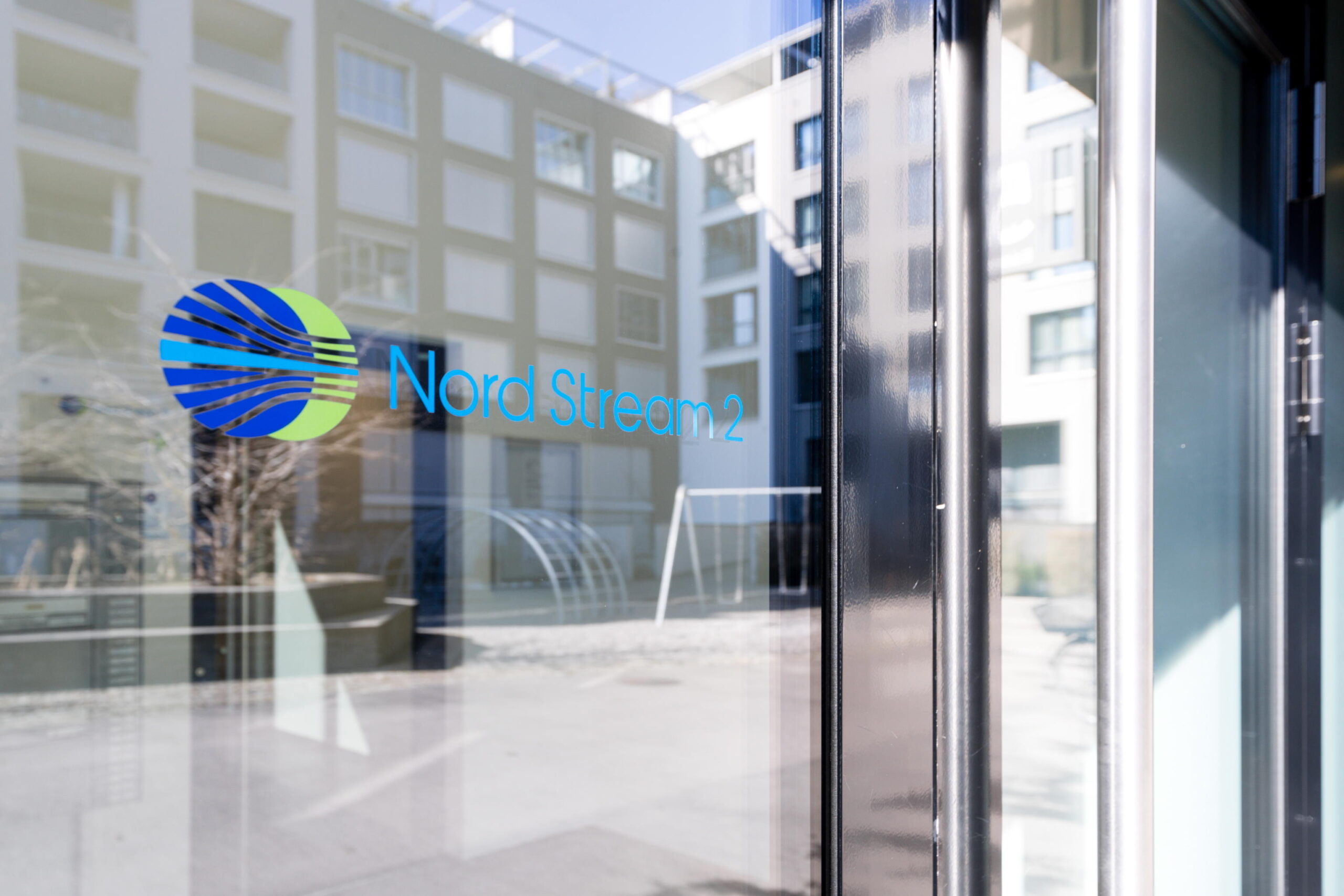 epa09793324 A Nord Stream 2 logo is seen on a reflected glass front of the company's Switzerland headquarters in Zug, Switzerland, 01 March 2022. Zug-based Nord Stream 2, which is implementing the gas pipeline between Russia and Germany, has carried out a mass layoff because of the sanctions taken against Russia. 140 people have lost their jobs, said Swiss Federal Councillor Guy Parmelin.  EPA/PHILIPP SCHMIDLI