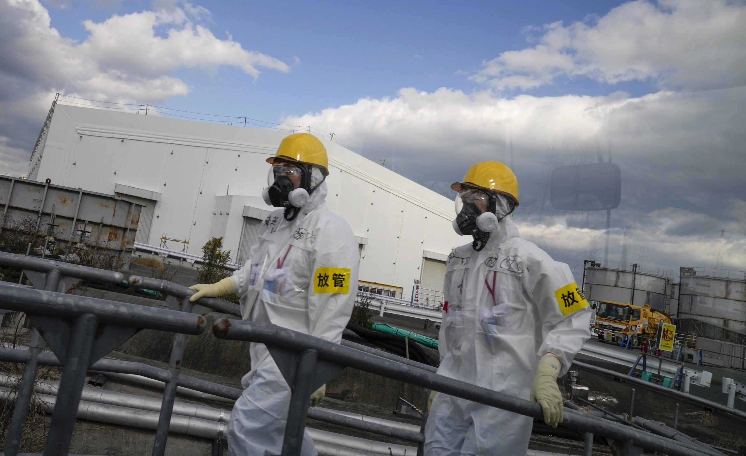 epa09583463 Workers wearing full-protective suits and masks walk past Multi-nuclide Removal Facility (Advanced Liquid Processing System = ALPS) during the decommissioning work at the tsunami-crippled Tokyo Electric Power Company's Fukushima Daiichi Nuclear Power Plant in Oma, Fukushima Prefecture, Japan, 15 November 2021. The Japanese government and TEPCO have estimated the decommissioning work will take between 30 and 40 years starting 2011, while contaminated water and treatment of fuel debris make the work more difficult. Former Japanese prime minister Yoshihide Suga said in April 2021 that releasing the treated water into the sea is a realistic solution. TEPCO plans to begin the release of contaminated water, treated by Multi-nuclide Removal Facility (Advanced Liquid Processing System = ALPS), into the Pacific Ocean through undersea tunnels in 2023.  EPA/KIMIMASA MAYAMA/POOL