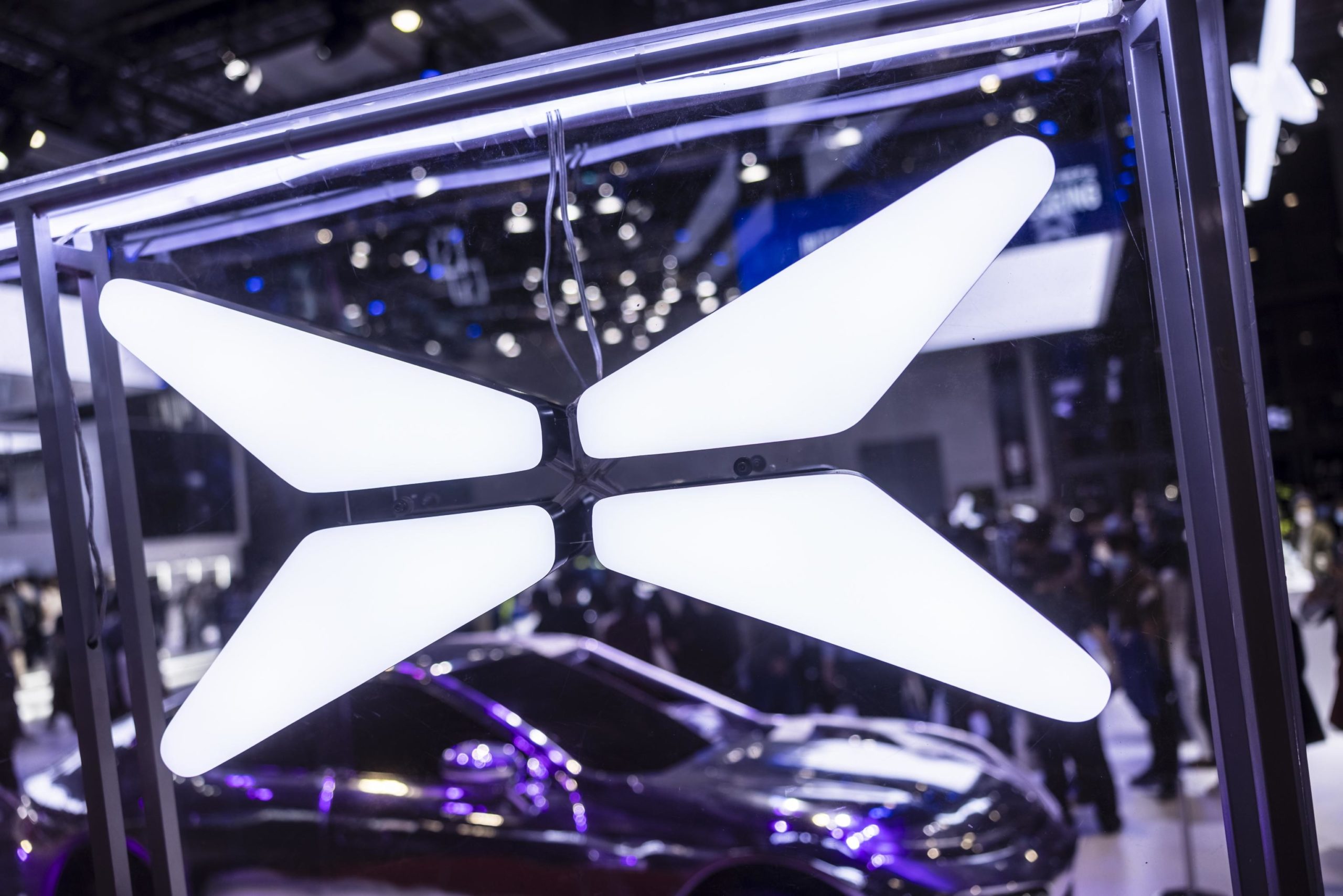 epa09149063 A logo of Xpeng is seen at the Xpeng trade fair stand during the first day of the Auto Shanghai 2021 motor show in Shanghai, China, 21 April 2021. The 19th International Automobile Industry Exhibition runs from 24 to 28 April.  EPA/Alex Plavevski
