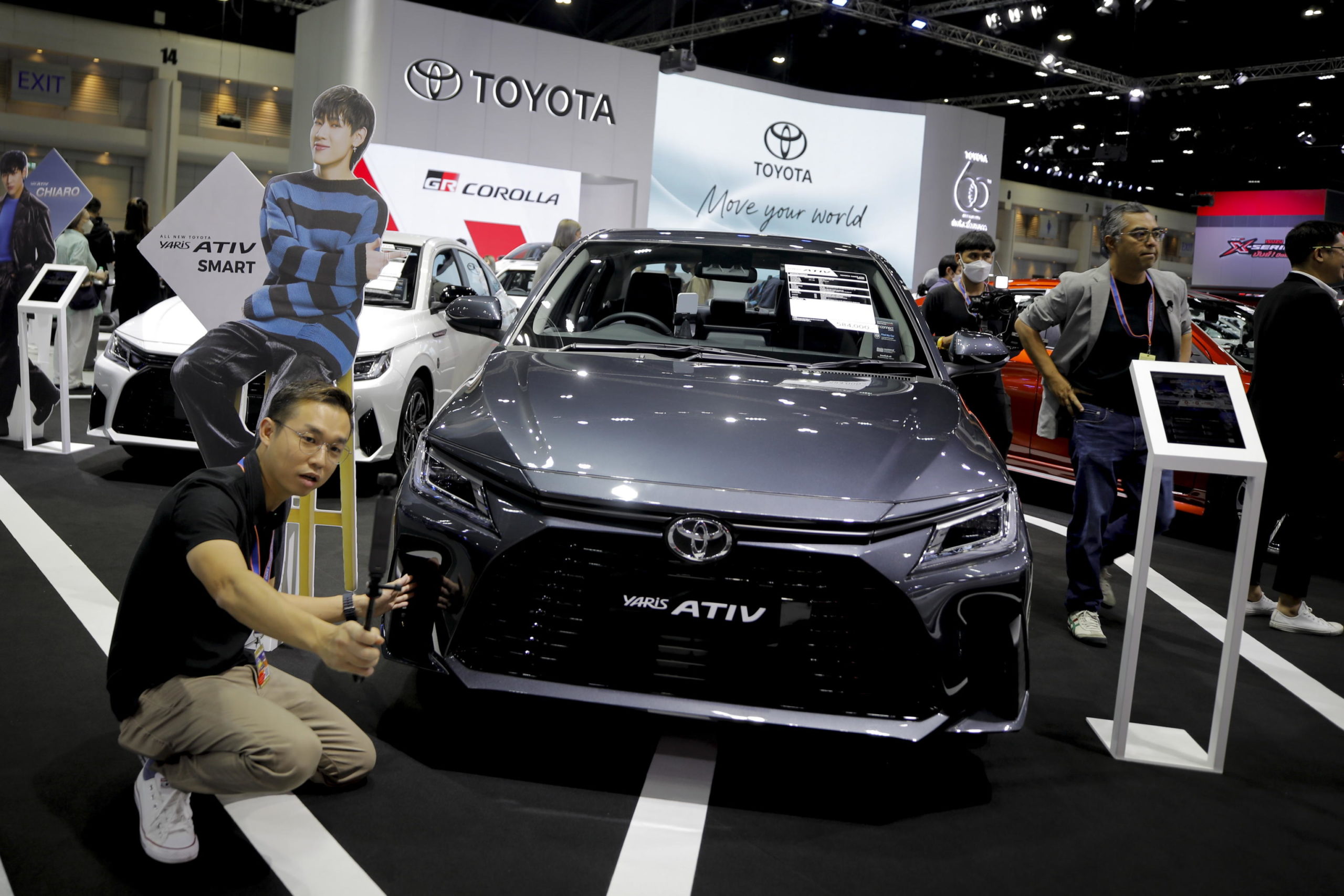epa10338452 A reporter films next to a Toyota Yaris Ativ during the media day of the 39th Thailand International Motor Expo 2022 in Bangkok, Thailand, 30 November 2022. More than 30 car brands as well as electric vehicles and motorcycles are showcased at the 12 day expo, running from 01 to 12 December 2022.  EPA/DIEGO AZUBEL