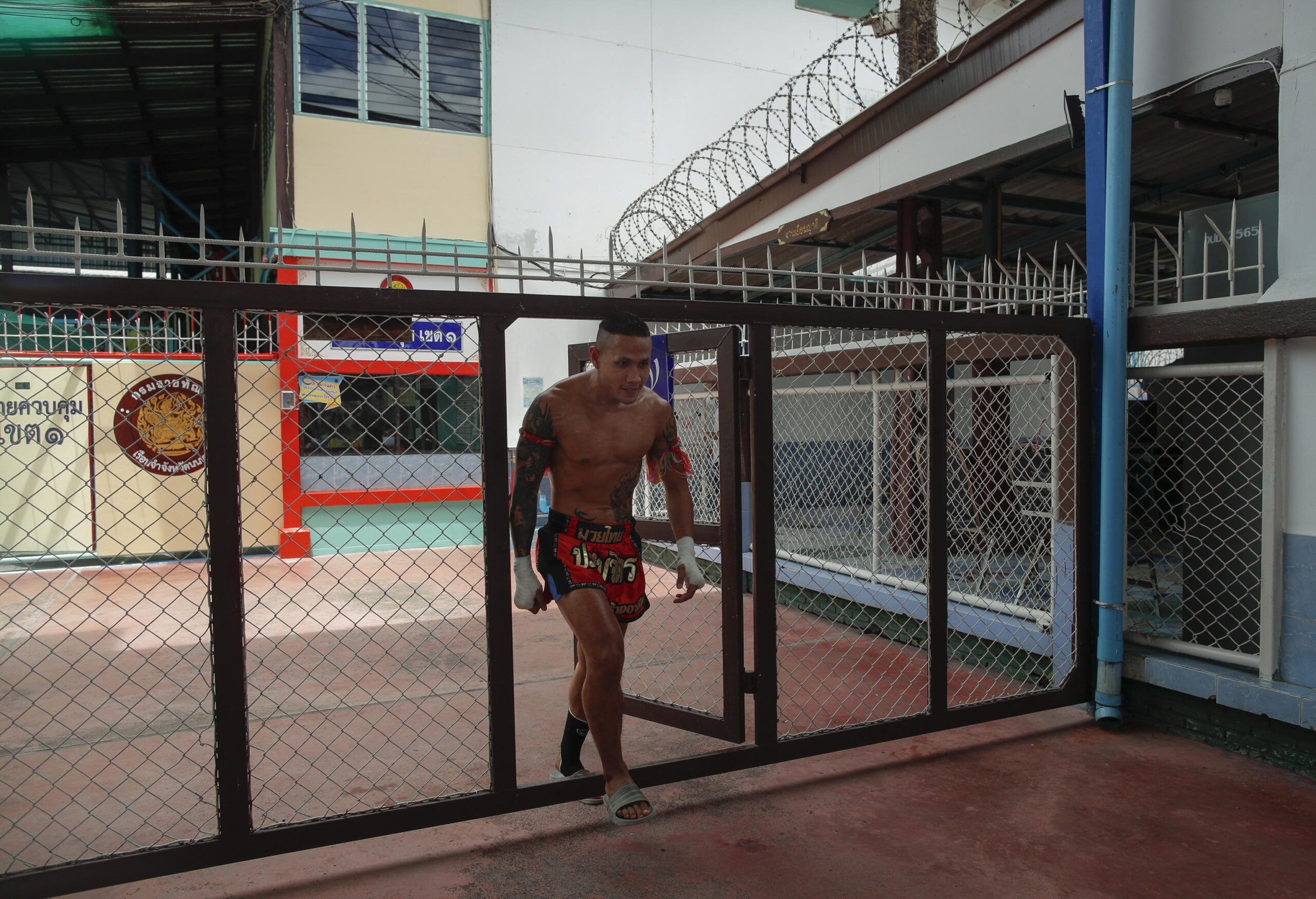 epa10115213 A Thai inmate nicknamed Detthewa Por Somchit walks in a prison area ahead of his bout during a Muay Thai Boxing competition between inmates and professional boxers as part of a Muay Thai boxing rehabilitation program at Nonthaburi Prison in Nonthaburi province, Thailand, 04 August 2022 (issued 11 August 2022). Muay Thai boxers traditionally use nicknames and their gym's name as last name. The Nonthaburi Prison named its gym Por Somchit to honor its warden, Preechida Somchit. The prison offers the social rehabilitation program to allow participanting inmates - currently 13 - to learn the national martial art combat sport of Muay Thai boxing. The project was launched in 2020 but had to be suspended due to the coronavirus disease (COVID-19) pandemic. The idea was to promote physical and mental health and discipline, reduce violence at the facility and help prepare the prisoners to reintegrate into society after their release. The men's prison, where most of those detained serve a sentence for drug-related crimes, also stages Muay Thai competitions between inmates and professional fighters with the support several Muay Thai Boxing gyms and a promoter to give the inmates real life experience of the fights. The bout 04 August 2022 was also held on the occasion of the national Mother's Day and the 90th birthday of Thai Queen Sirikit, the Queen Mother.
Thailand has the largest prison population in Southeast Asia and one of the world's most overcrowded prison systems. Most prisoners are held for drug offense, according to an International Federation for Human Rights report. EPA/RUNGROJ YONGRIT ATTENTION: This Image is part of a PHOTO SET