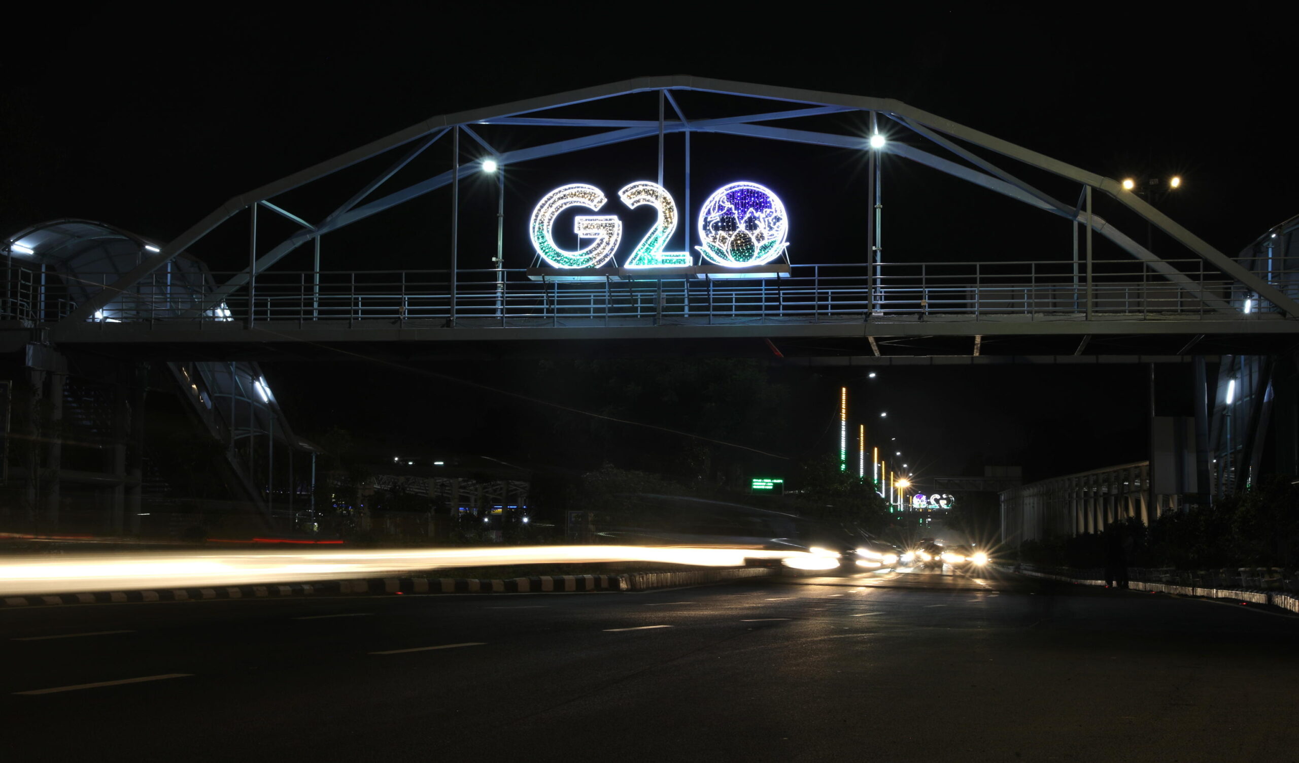 epa10804430 Vehicles drive past an illuminated G20 logo in New Delhi, India, 17 August 2023. The 18th G20 Heads of State and Government Summit will be held in New Delhi on 09 and 10 September 2023.  EPA/RAJAT GUPTA TAKEN WITH SLOW SHUTTER SPEED