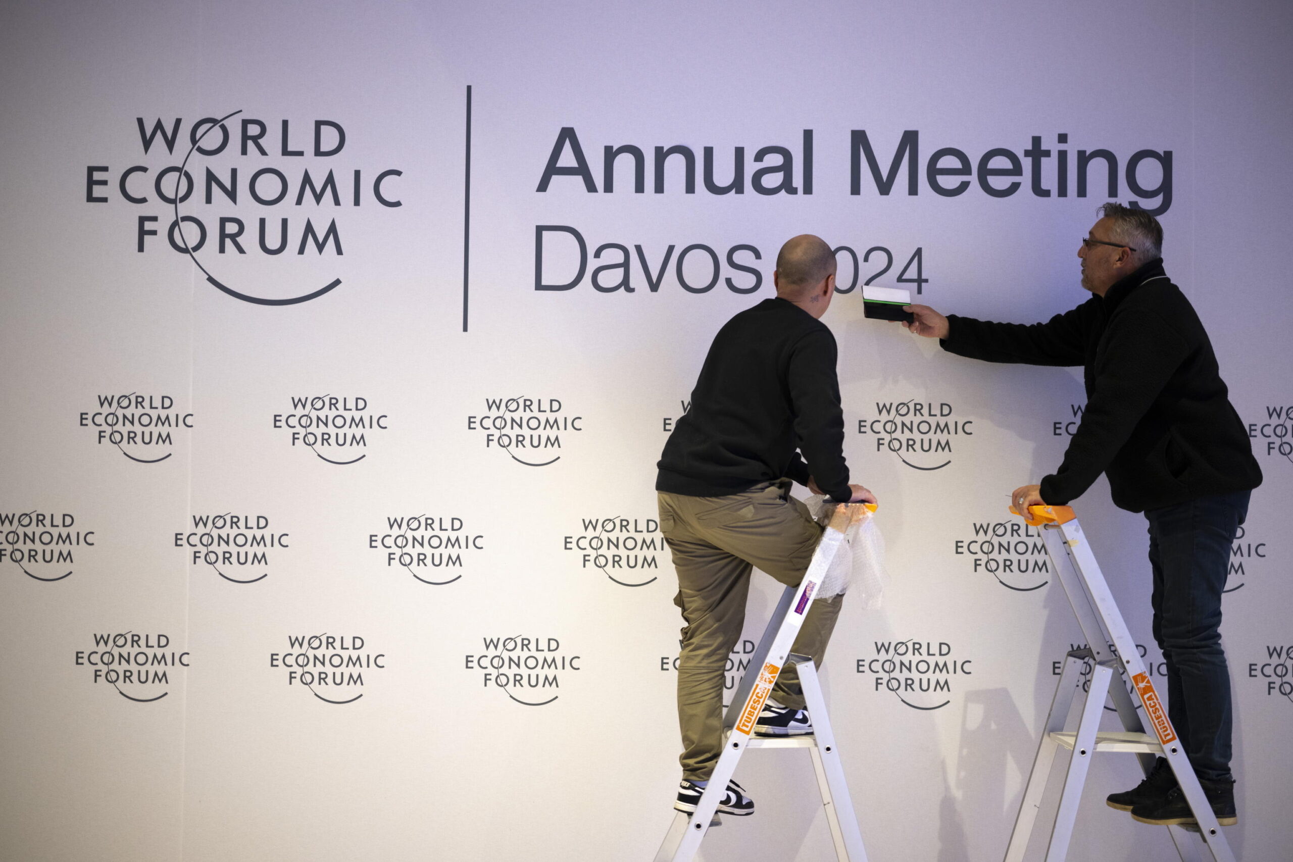 epa11075914 Workers set up letters before the 54th annual meeting of the World Economic Forum (WEF), in Davos, Switzerland, 14 January 2024. The 54th annual meeting of the World Economic Forum (WEF) brings together entrepreneurs, scientists, and corporate and political leaders in Davos under the topic 'Rebuilding Trust' and will run from 15 to 19 January.  EPA/GIAN EHRENZELLER